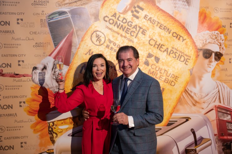 Libby Brodie and Matthew Jukes raising a toast at a celebratory event, smiling and holding a glass, conveying joy and success