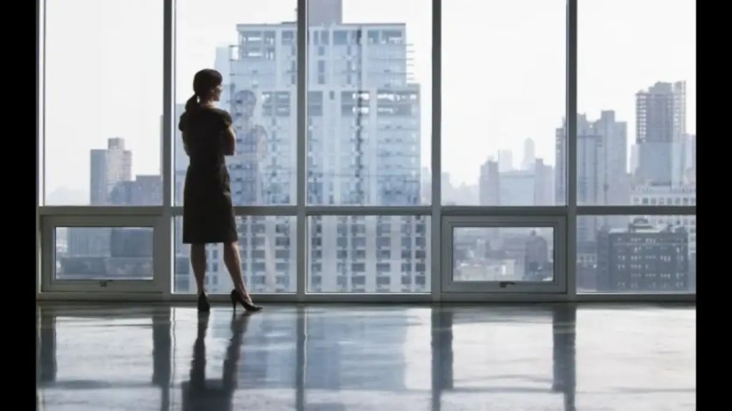 Confident female business leader analyzing financial reports, representing the challenges of being a UK female breadwinner