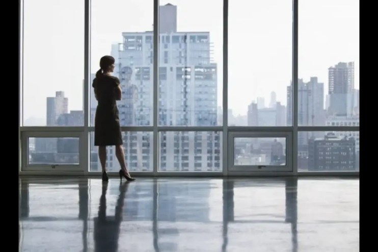 Confident female business leader analyzing financial reports, representing the challenges of being a UK female breadwinner