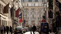 Mayfair street view showcasing luxury shops, bustling activity, and elegant architecture in a prominent business district