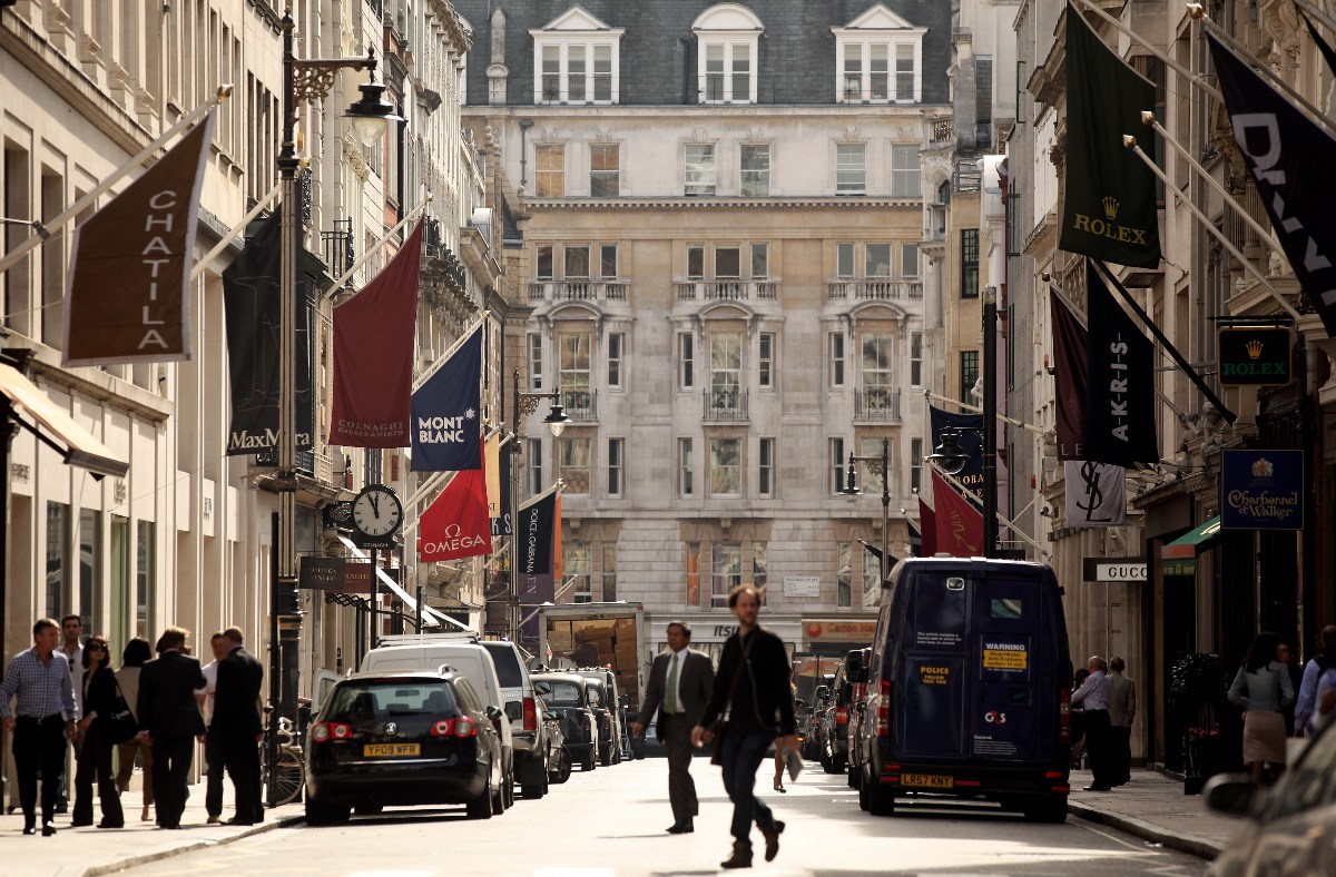 Mayfair street view showcasing luxury shops, bustling activity, and elegant architecture in a prominent business district