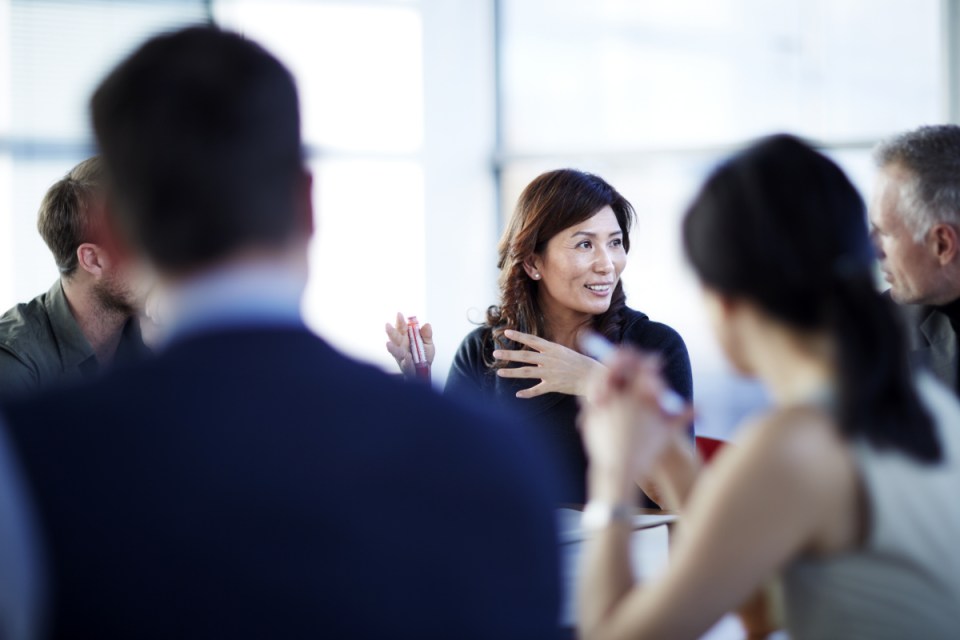 High-resolution stock image with business professionals collaborating in a modern office setting, emphasizing teamwork and...