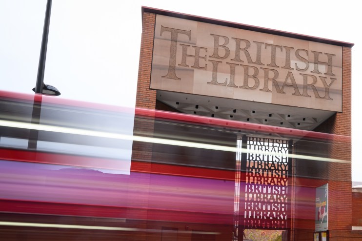 Exterior view of the British Library in London, showcasing its iconic architecture and entrance area, on a sunny day.