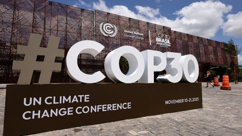 Delegates discussing climate policies at COP30 summit 2023, highlighting international efforts for sustainable development.