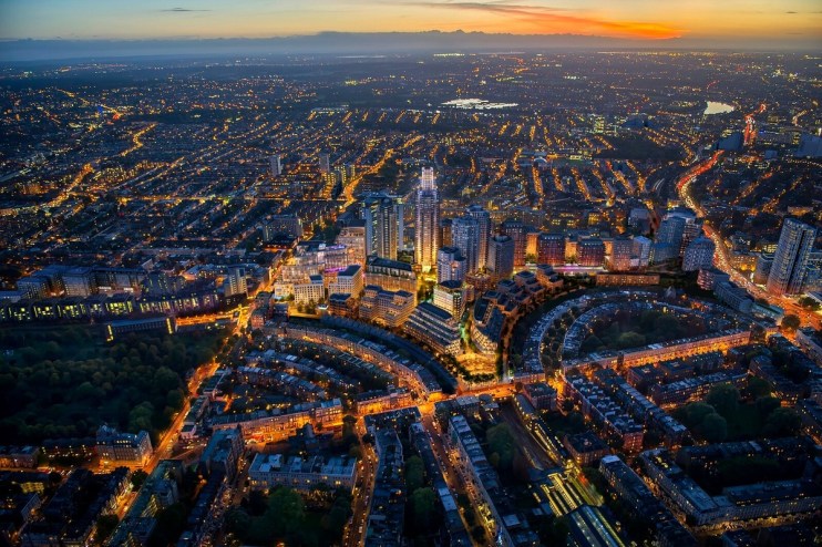 Aerial view of Earls Court Masterplan at dusk showcasing urban development and architectural layout in London