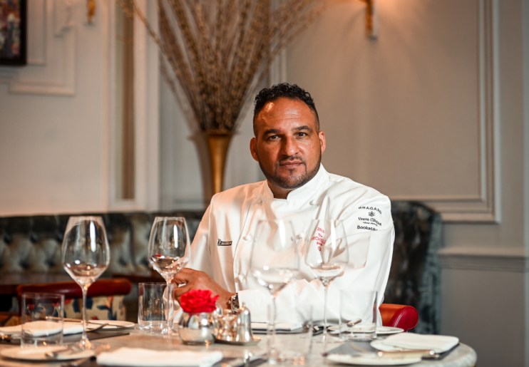 Renowned chef Michael Caines presenting his signature dish at a culinary event, showcasing innovative fine dining techniques.