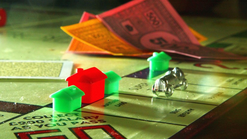 Classic Monopoly board game with colorful properties, iconic tokens, and dice capturing the essence of strategic real esta...