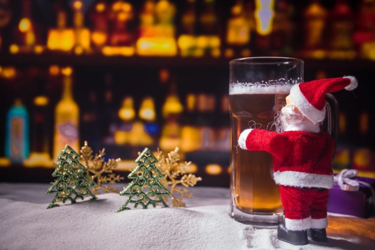 Festive pub interior adorned with Christmas decorations, sparkling lights, and patrons enjoying holiday cheer