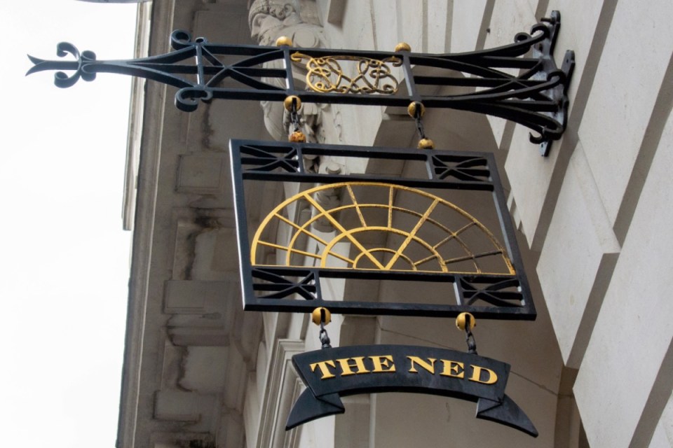 The Ned hotel exterior showcasing modern architecture in a bustling business district