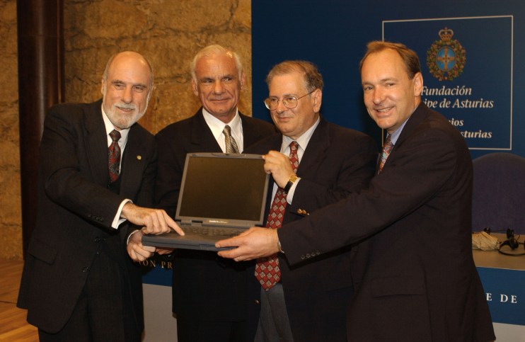 Tim Berners-Lee speaking at a tech conference, emphasizing the importance of internet accessibility and innovation.
