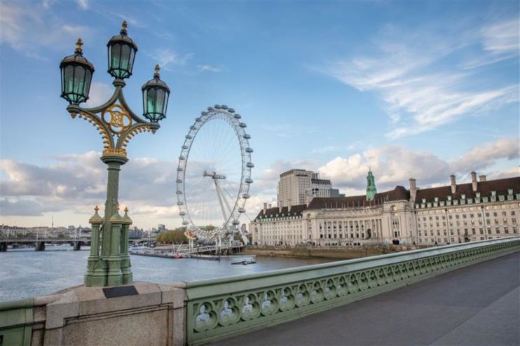 Tourists exploring city streets as new tourism tax policy impacts travel costs and local economies