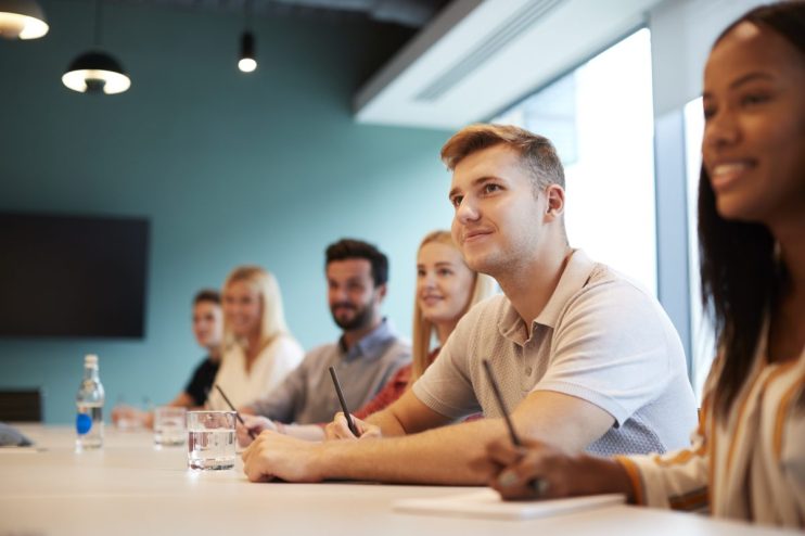 Young professionals collaborating in a modern office space, showcasing teamwork and innovation in a business environment.