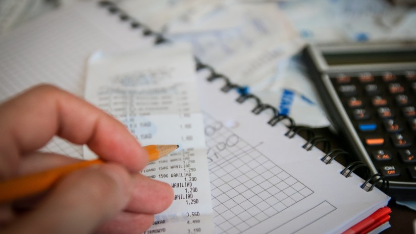 Stacks of currency notes and coins symbolizing financial accounts and monetary transactions on a business news site.