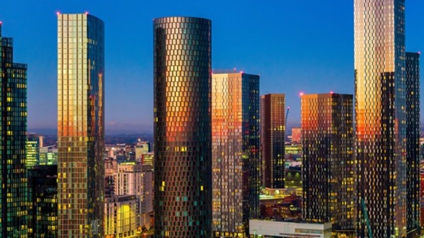 Manchester skyline with iconic landmarks during a Belfast speech event, highlighting urban landscape and architectural bea...