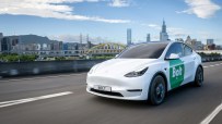 Electric Bolt car parked in urban setting, showcasing sleek design and eco-friendly transportation for modern city living.