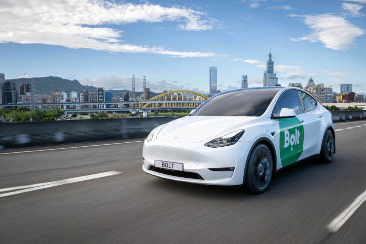 Electric Bolt car parked in urban setting, showcasing sleek design and eco-friendly transportation for modern city living.