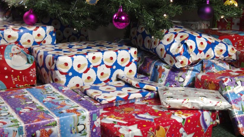 Festive holiday scene with beautifully wrapped Christmas gifts under a decorated tree, perfect for seasonal celebrations.