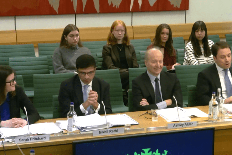 FCA committee discusses financial regulation reforms, chaired by Alder, in a formal meeting setting with documents and lap...