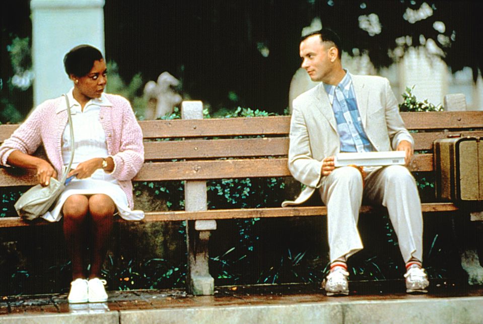 Iconic bench from Forrest Gump movie scene, surrounded by lush greenery in a park setting, symbolizing nostalgia and film ...