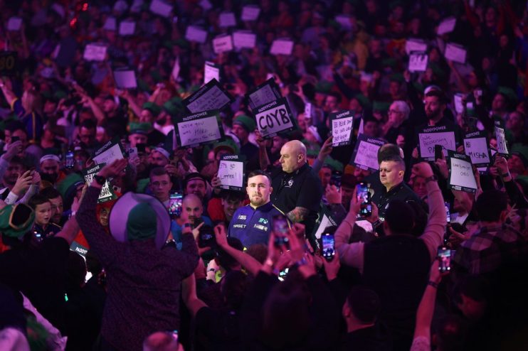 GettyImages 2192426400 shows a significant business event, with professionals engaging in discussions, highlighting indust...