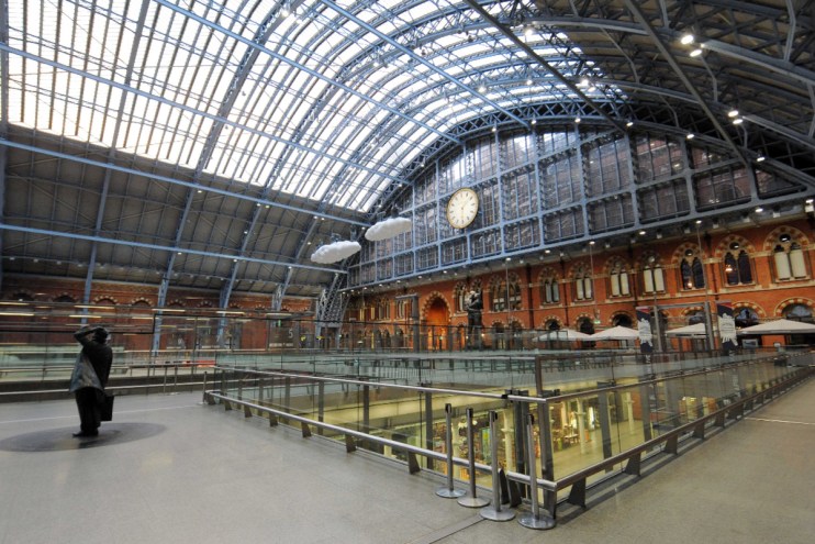 St Pancras International Station bustling with commuters and travelers, showcasing architectural grandeur and vibrant acti...