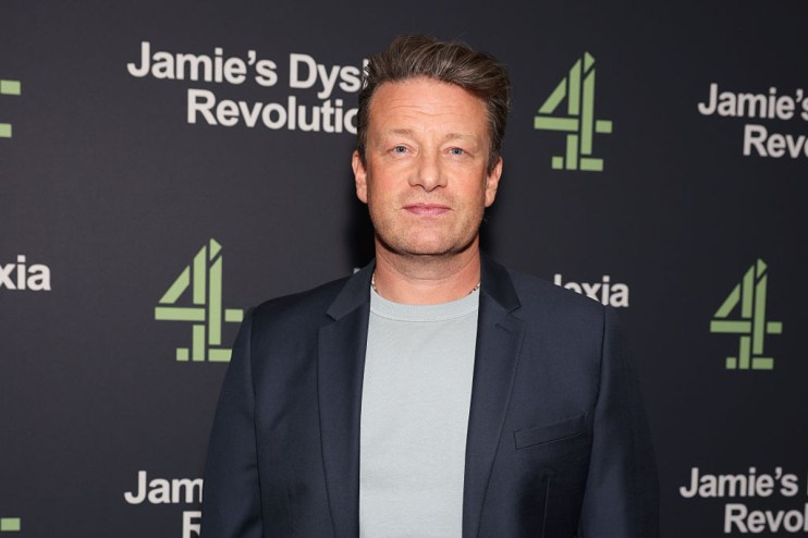 Jamie Oliver speaking at a culinary event, showcasing healthy recipes and sustainable cooking practices.