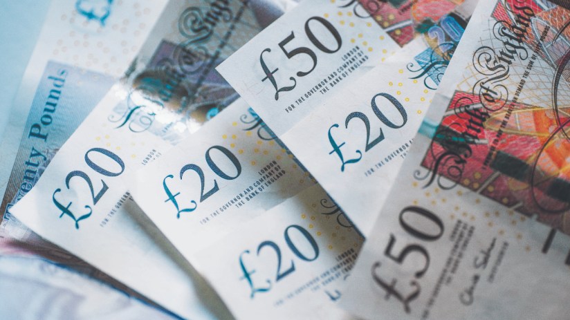 Stacks of various currency bills symbolizing financial news and economic trends on a business website
