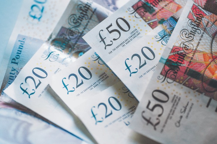 Stacks of various currency bills symbolizing financial news and economic trends on a business website