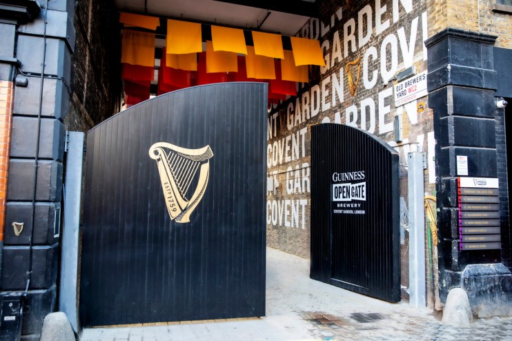 Open gate on December 1st at event, showcasing festive decorations and welcoming crowd at business venue.