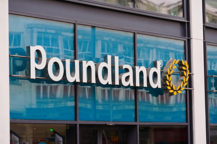 Poundland storefront with shoppers entering and exiting, showcasing the brands logo and discount signage in a bustling str...