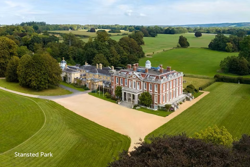 Stansted Park landscape featuring historic architecture and lush gardens under a clear blue sky