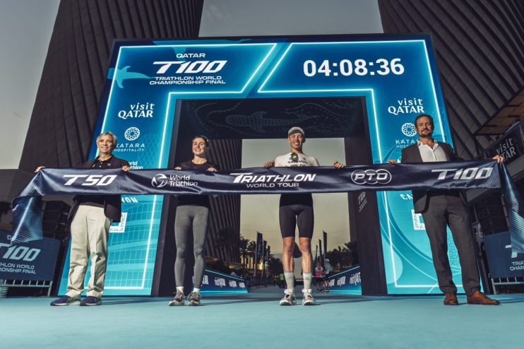 Triathletes compete in Qatar World Tour with clear skies, showcasing endurance and athleticism on a diverse race course