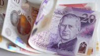 British pound banknotes in various denominations, highlighting UK currency amidst economic discussions