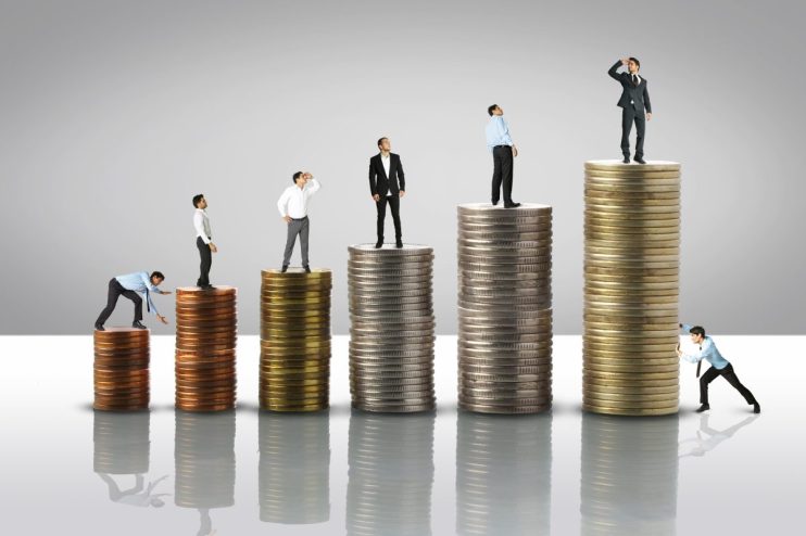 Corporate executives discussing compensation strategy at a boardroom meeting, highlighting executive pay trends.