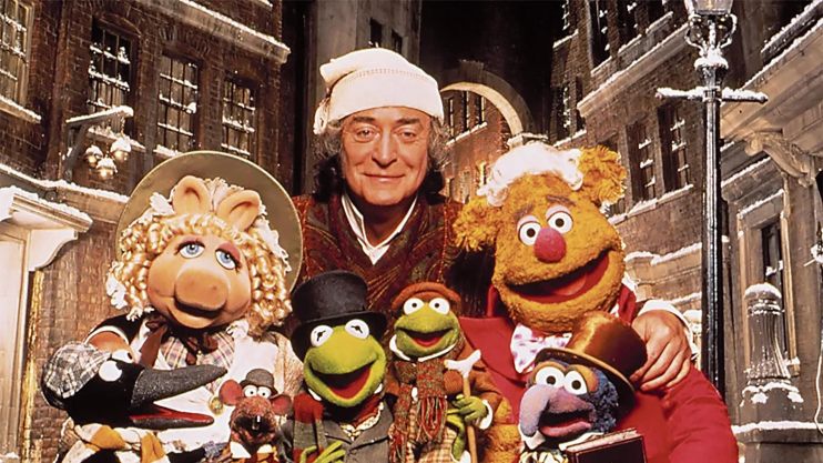 Colorful Muppets characters performing on stage with vibrant backgrounds and props, showcasing a lively theatrical scene.