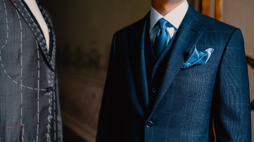 Tailored suit jacket on display at Sartoria, highlighting fine craftsmanship and elegant design in a business setting