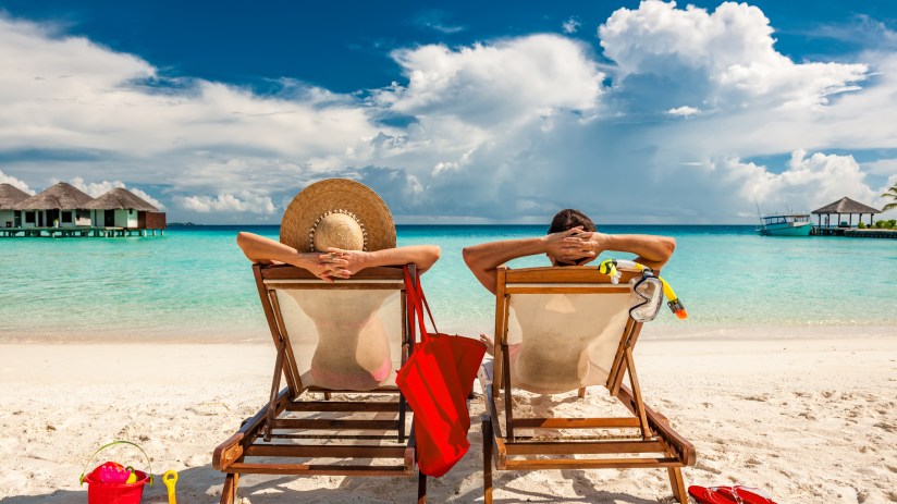 Sunny winter beach scene with golden sand, clear blue sky, and gentle waves, ideal for a relaxing holiday getaway.