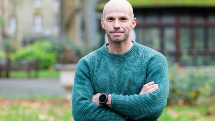 Alex Cooper, CEO of Electric Twin, delivering a keynote speech at a business conference, emphasizing innovation in technol...
