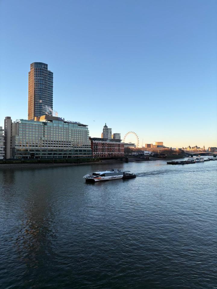 Blackfriars Bridge at sunrise with vibrant cityscape, capturing iconic London architecture and Thames River reflections.