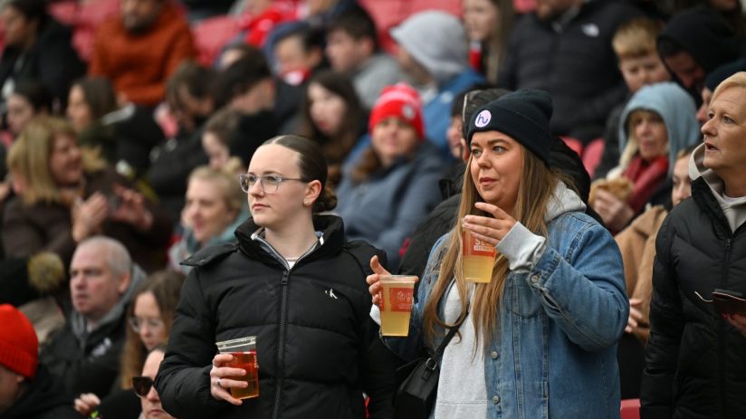Bristol City fans celebrating in the stadium stands, showcasing team spirit and vibrant club colors during a match day