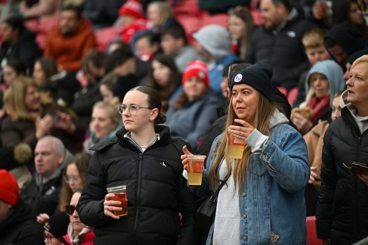Bristol City fans celebrating in the stadium stands, showcasing team spirit and vibrant club colors during a match day