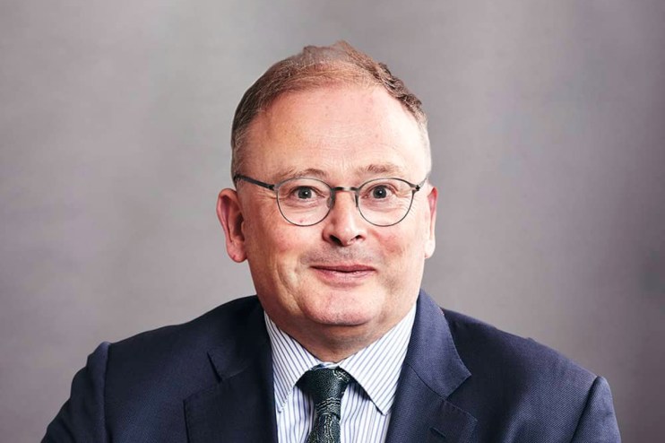 David Lockwood standing confidently with a professional demeanor, dressed in business attire, likely related to business n...