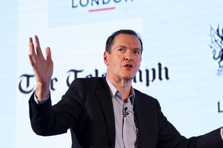 George Osborne speaking at a business conference, wearing a suit and tie, addressing economic policies and financial strat...