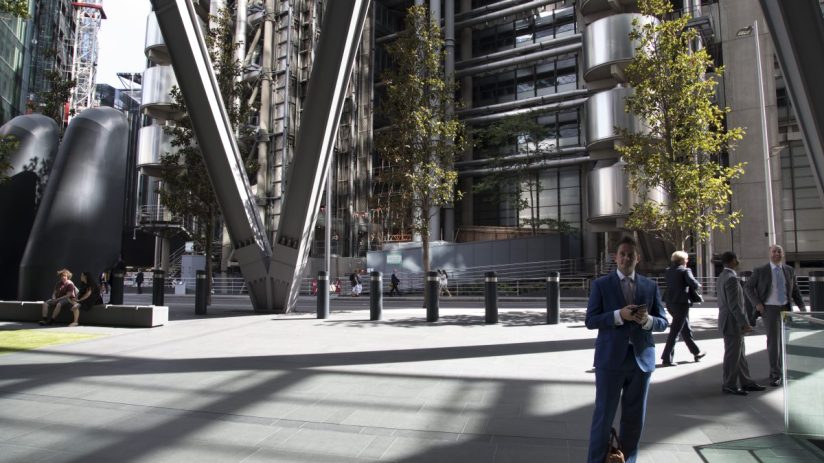 Lloyds of London iconic building exterior with modern architecture and bustling city street in the foreground