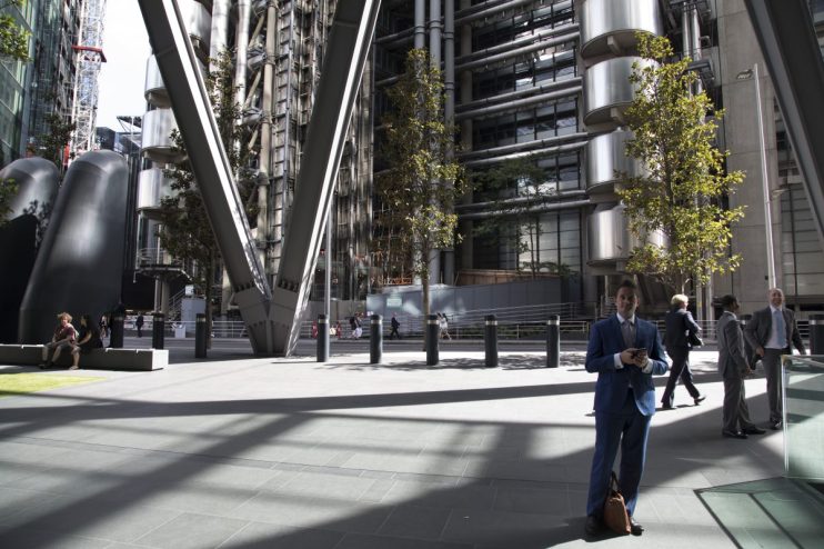 Lloyds of London iconic building exterior with modern architecture and bustling city street in the foreground