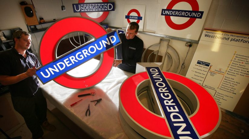 London Underground roundel symbol at a station entrance, iconic blue and red design representing public transit in the UK ...