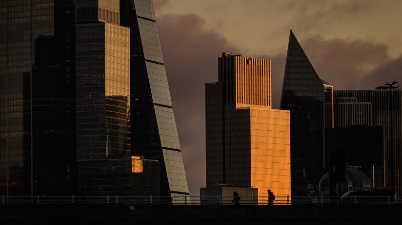 London city skyline at dawn with iconic landmarks like The Shard and Tower Bridge under a vibrant morning sky