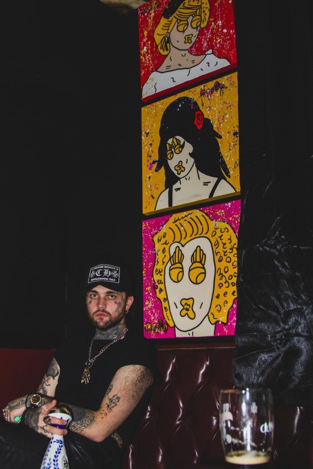 Mason Newman presenting his Indelible Fine Art collection in a gallery setting, showcasing vibrant and intricate artwork.