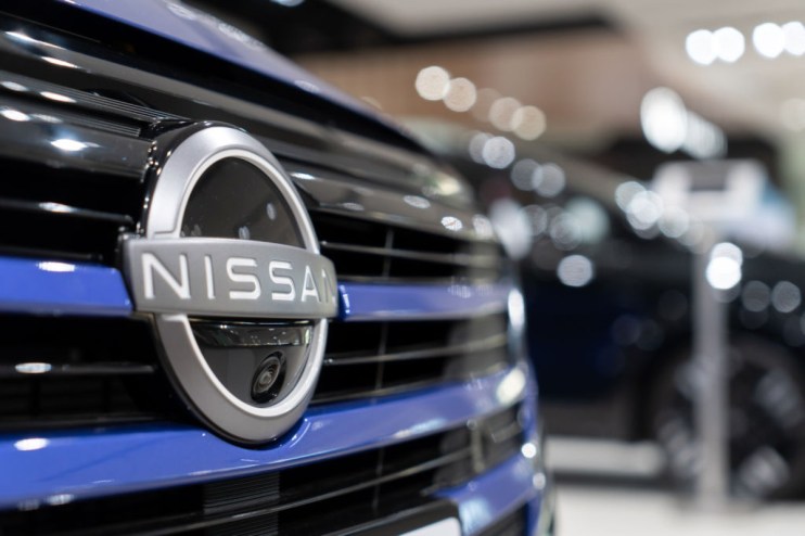 Nissan UK dealership showcasing latest car models in showroom with modern design and branding elements visible