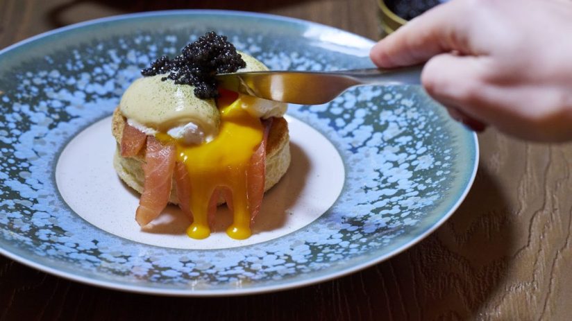 Gourmet breakfast spread at Pavyllon showcasing artisan pastries, fresh fruit, and elegant table setting for a luxurious d...